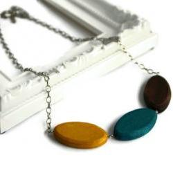 Chunky bead necklace. Trendy necklace with wood beads in brown, teal and yellow.